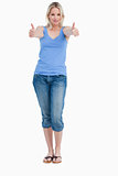 Blonde woman standing upright while placing her thumbs up