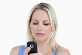 Serious blonde woman holding her cellphone