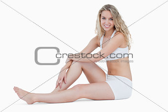 Smiling teenage sitting on the floor in underwear