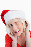 Young woman wearing Christmas clothes while blinking an eye