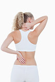 Blonde woman showing pain in her back and in her neck