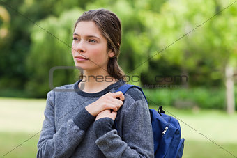 Young calm girl looking towards the side while standing in the c