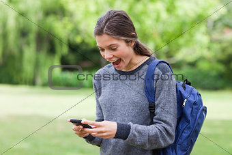 Young girl showing her surprise after receiving a text