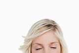 Woman closing her eyes while hiding the lower part of her face