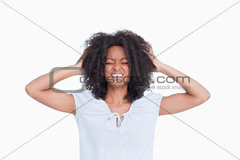 Young woman showing her anger by holding her head