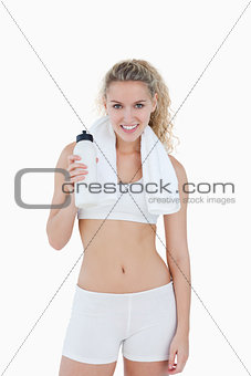 Young smiling woman standing with a towel around her neck