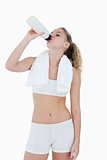 Young woman drinking water during sports