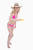 Young beautiful woman playing frisbee