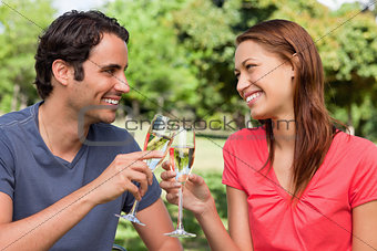 Two friends  touching their glasses together in celebration