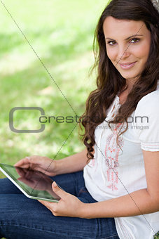 Young smiling woman looking at the camera while sitting down