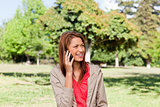 Young woman talking on the phone while looking toward the side i