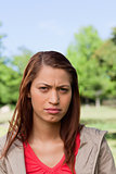 Woman looking ahead of her with a serious expression on her face