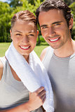 Woman holding a towel smiling with a man
