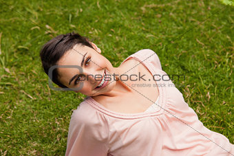 Smiling woman tilting her head while lying down