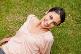 Smiling woman looking upwards while lying down