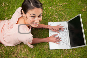 Woman looking upwards while using laptop 