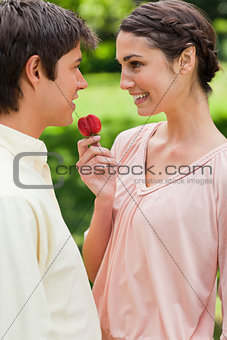 Woman laughing while offering a strawberry to her friend