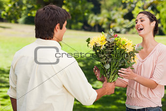 Man presents his friend with flowers