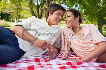 Two friends looking at each other while having a picnic