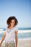 Young smiling woman standing on the beach