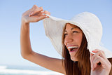 Young attractive woman screaming of joy in front of the sea