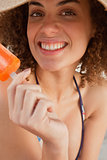 Young woman showing a great smile while holding a popsicle