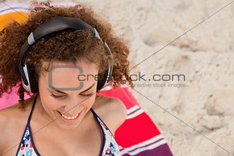 Smiling young woman listening to music with her headset