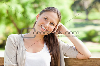Smiling woman enjoying her day on a bench