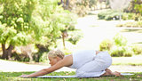 Side view of a woman doing stretches in the park