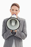 Angry businesswoman shouting into megaphone