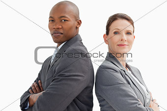 business people with hands crossed looking at camera