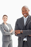 Smiling businessman and woman with folded hands