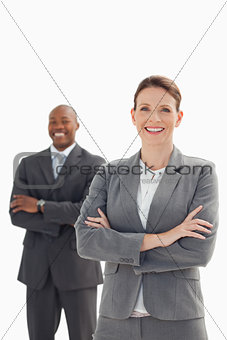 Smiling businesswoman in front of smiling businessman