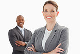 Smiling businesswoman and man with arms crossed 