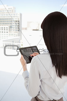 A woman in her office using her tablet pc