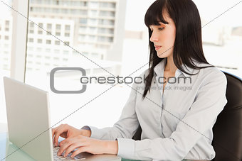 A woman on her laptop typing