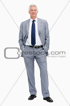 Portrait of a man in a suit with hands in the pockets