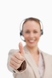 Thumbs up of a businesswoman wearing a headset