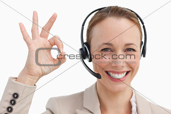 Woman in a suit with a headset approving