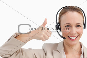 Woman in a suit with a headset the thumb-up 