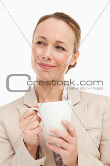 Woman in a suit holding a mug