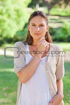 Thoughtful woman standing in the park