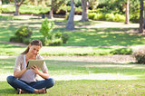 Woman in the park with a tablet computer