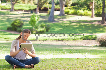 Woman in the park with a tablet computer