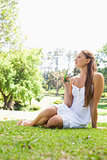 Woman sitting on the grass in a park