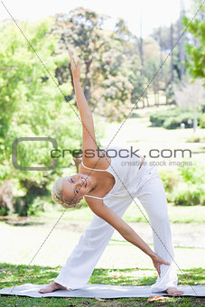 Woman doing warm up exercises in the park