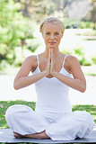 Relaxed woman on the lawn in a yoga position