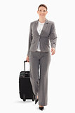 Businesswoman walking forward with a suitcase