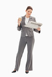 Businesswoman reading newspaper and holding coffee