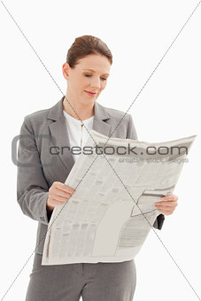 Businesswoman reading newspaper